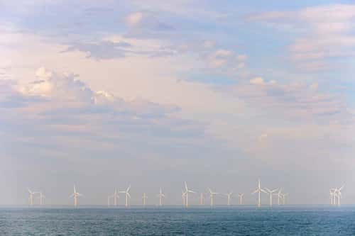 Wind turbines, offshore farm array and service boat close to Liverpool, Irish Sea, September 2011
