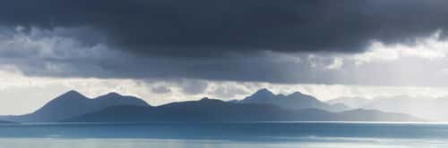 The iconic summits of the Cuillin Hills and Outliers on the Isle of Skye, viewed from across the Inner Sound near Applecross, Scotland, UK, August