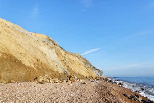 Collapsed section of 200 metre high sandstone cliff, one of the biggest UK cliff falls in 60 years, Seatown, Dorset, UK, October 2023