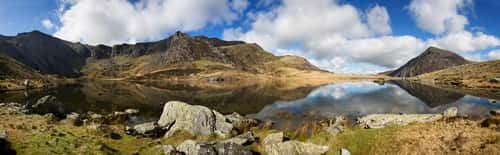 Devils Kitchen with reflections in Llyn Idwal leading round to Pen Yr Ole Wen, Cwm Idwal, Snowdonia, North Wales, April
